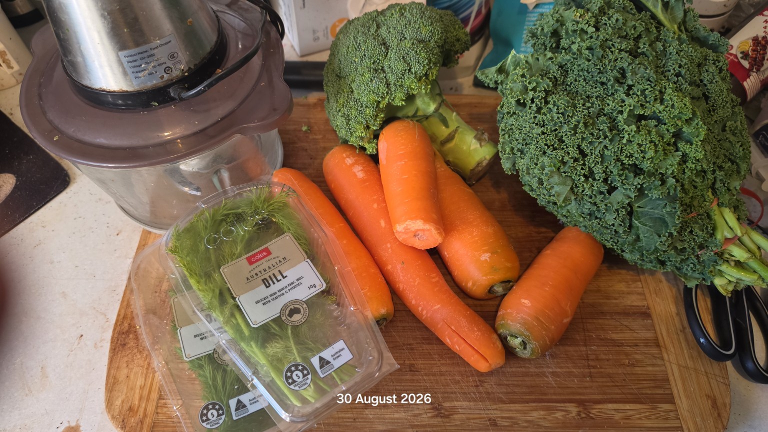 Carrots, broccoli, kale and fresh dill ready to be washed and chopped